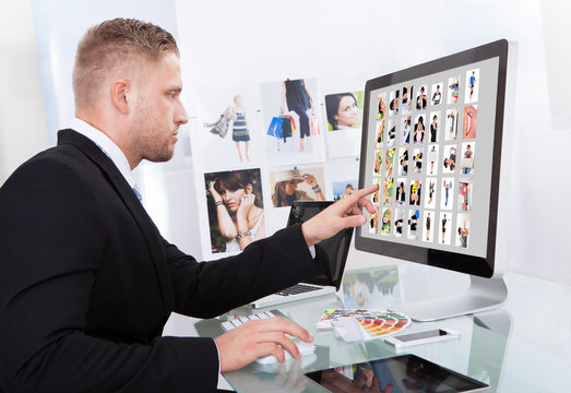 Businessman editing photographs