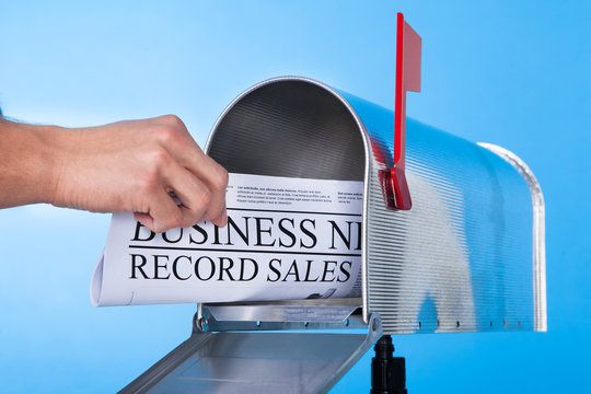 Man opening his mailbox to remove mail