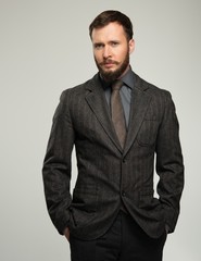 Fototapeta premium Handsome well-dressed man in jacket over his shoulder