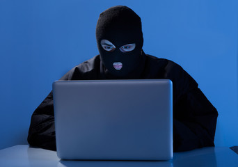 Criminal Using Laptop To Hack Online Account