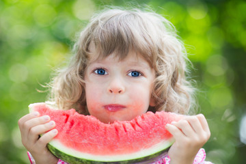 Happy child eating watermelon