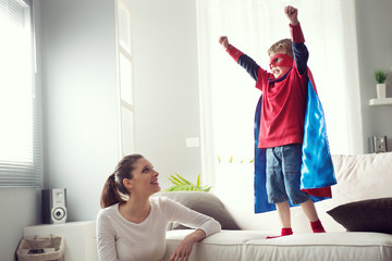 Little superhero with his mother