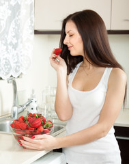  woman  with  plate of strawberries