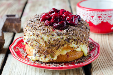 Sponge cake with cream, cherries and chocolate