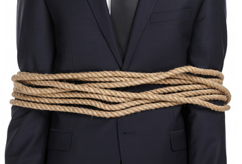 Close up of businessman tied with the rope, isolated on white