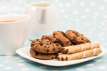 coffee and milk with chocolate cookies and wafer rolls
