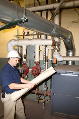Engineer with hard hat and blueprint