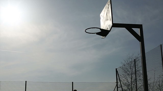 Basketball player silhouette fancy slam dunk