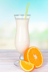 Milk shake on table on light blue background