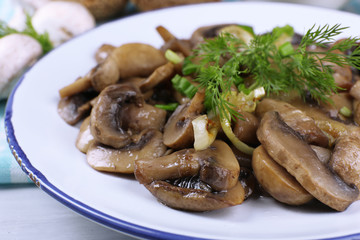 Delicious fried mushrooms on plate on table close-up
