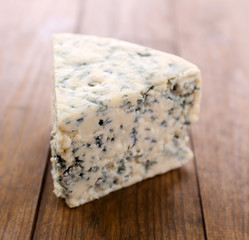 Tasty blue cheese, on wooden table