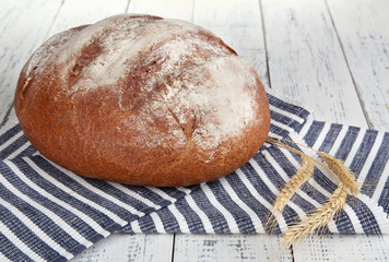 Rye bread on napkin on wooden background
