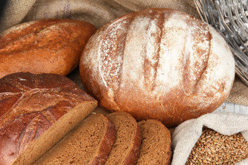 Rye bread with grains on table on sackcloth background