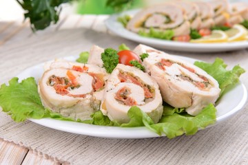 Delicious chicken roll on plate on table close-up