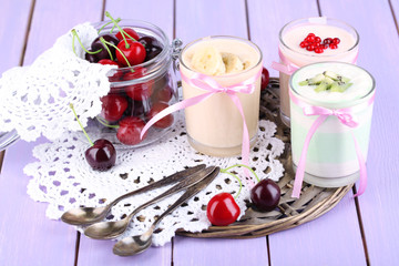 Delicious yogurt with fruits tastes in glasses and fresh fruits