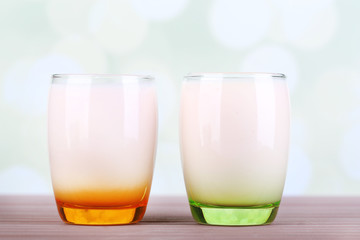 Delicious yogurt with fruits tastes in glasses
