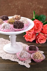 Set of chocolate candies on table on brown background