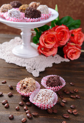 Set of chocolate candies on table on brown background