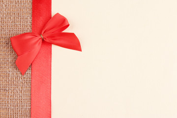Sackcloth with color ribbon and bow on color paper background