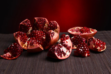Ripe pomegranates on table close-up