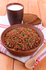 Boiled buckwheat in bowl on table close-up