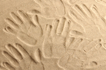 Hand prints in sand as nice summer background