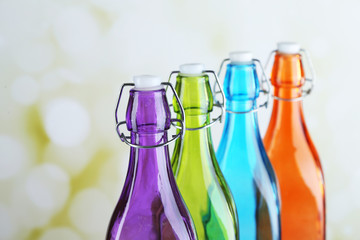 Colorful bottles on light background