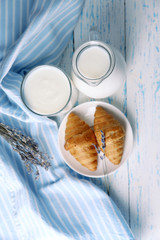 Homemade yogurt in jug and tasty croissants
