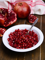 Ripe pomegranates on table close-up