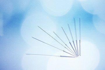 Needles for acupuncture on blue background - obrazy, fototapety, plakaty