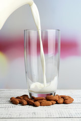 Almond milk is poured into glass,