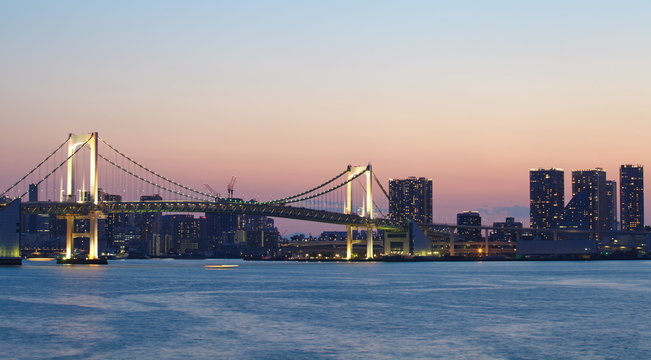 view of tokyo bay with rainbow bridge at sunset time