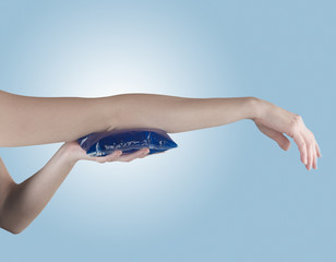Fototapeta premium Holding ice gel pack on elbow. Medical concept photo.