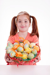 Fototapeta na wymiar young smiling freckles girl holding a basket of Easter eggs