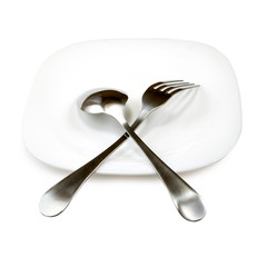 Isolated image of spoon fork and plate closeup