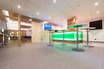 low view to wooden foyer with illuminated bar desk