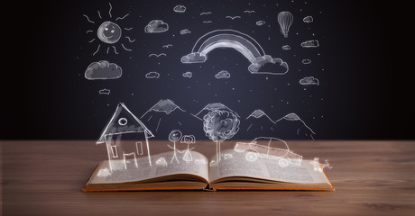 Open book with hand drawn landscape