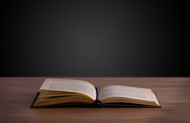 Open book on wooden deck