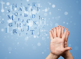 Happy smiley fingers looking at mixture of bokeh letters