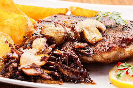 Fried pork chop with mushrooms and chips