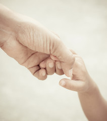 Mother holding a hand of child