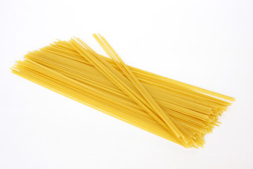 Raw pasta on white background