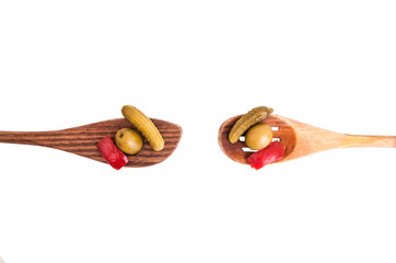 wood spoons and assorted peppers on white