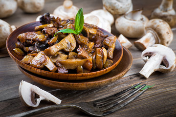 Fresh champignons on a wooden board