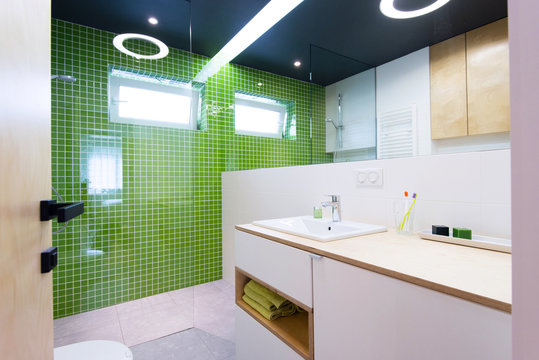 interior of modern bathroom with green tiles