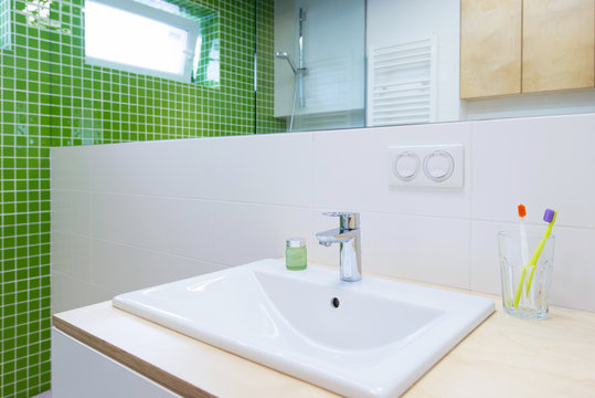 wash basin with faucet in green bathroom