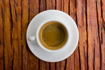 Cup of fresh espresso on table