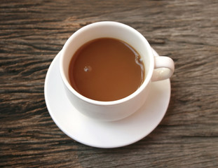coffee in a white cup on wooden