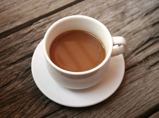 coffee in a white cup on wooden