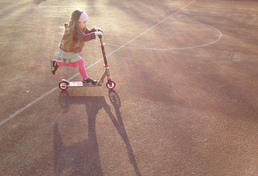 Little Girl Riding Scooter